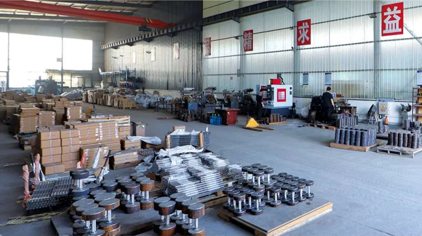 Production floor with chrome dumbbells and weight plates staged for inspection